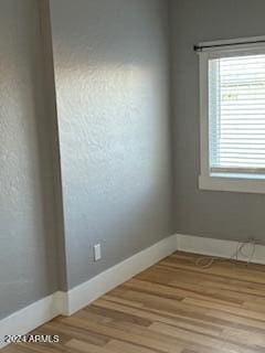 spare room with light wood-type flooring