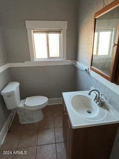 bathroom featuring vanity, tile patterned floors, and toilet