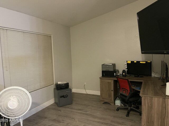 home office with baseboards and wood finished floors