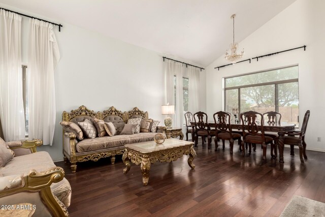 living room with a chandelier, vaulted ceiling, and wood finished floors