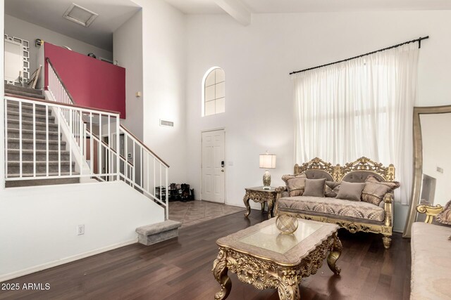 living room with high vaulted ceiling, stairs, and wood finished floors