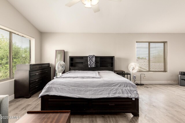 bedroom featuring baseboards, ceiling fan, wood finished floors, and vaulted ceiling
