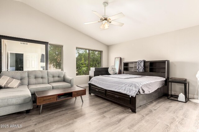 bedroom featuring visible vents, a ceiling fan, wood finished floors, and high vaulted ceiling