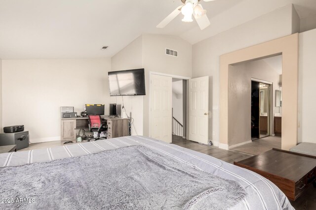 bedroom featuring baseboards, visible vents, wood finished floors, and vaulted ceiling