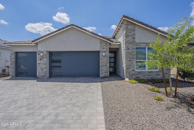 10509 W Harmony Ln, Peoria, AZ 85382 - view of front of house with stone siding, stucco siding, and a garage