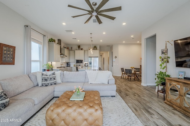 10509 W Harmony Ln, Peoria, AZ 85382 - living area with a ceiling fan, light wood-style flooring, recessed lighting, and baseboards