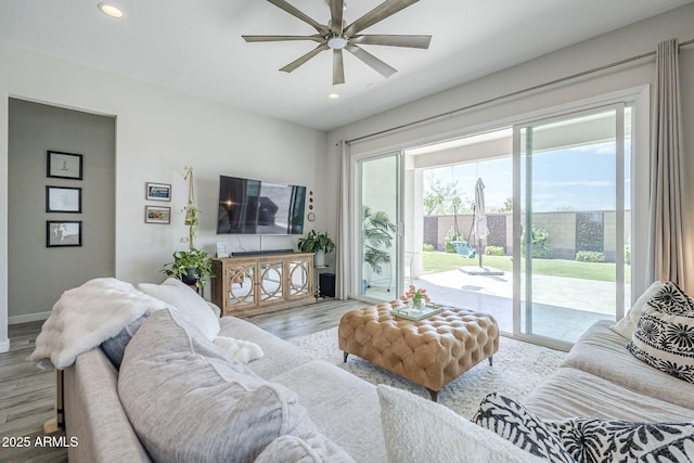 10509 W Harmony Ln, Peoria, AZ 85382 - living area featuring healthy amount of natural light, wood finished floors, ceiling fan, recessed lighting, and baseboards