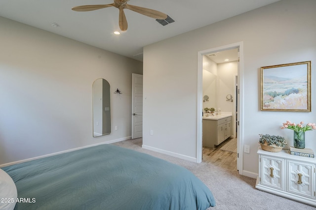 10509 W Harmony Ln, Peoria, AZ 85382 - bedroom with light carpet, baseboards, connected bathroom, arched walkways, and recessed lighting