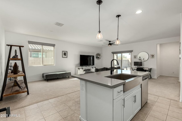 kitchen featuring light carpet, sink, decorative light fixtures, and stainless steel dishwasher