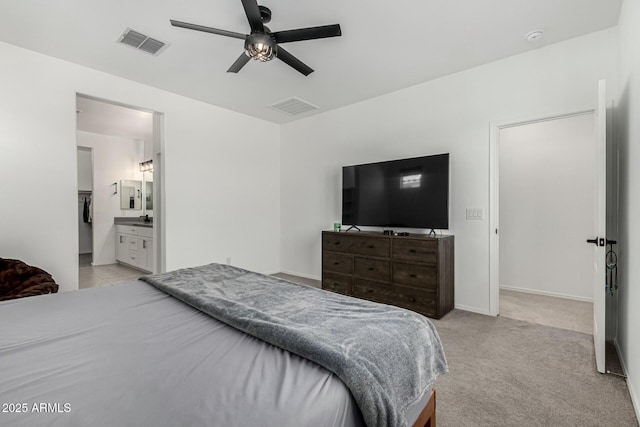 bedroom with light carpet, connected bathroom, and ceiling fan