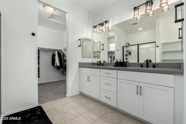 bathroom with vanity, walk in shower, and tile patterned floors