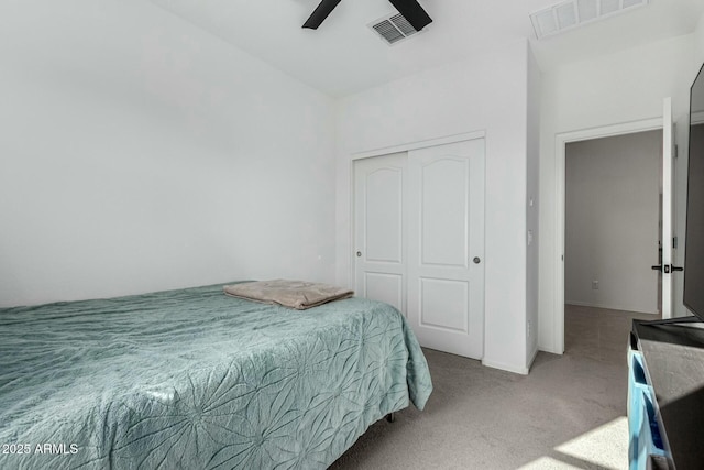 carpeted bedroom with a closet and ceiling fan