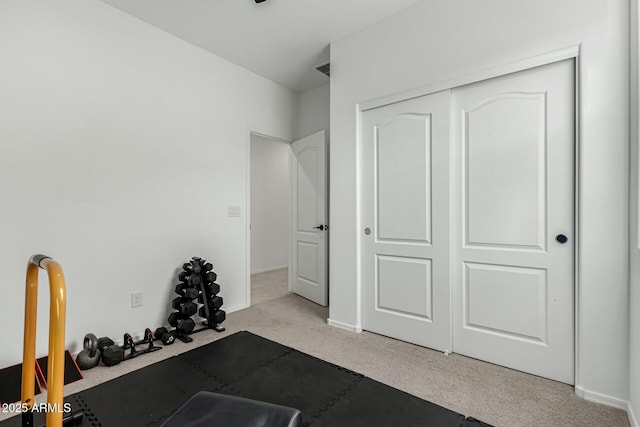 workout area featuring light carpet