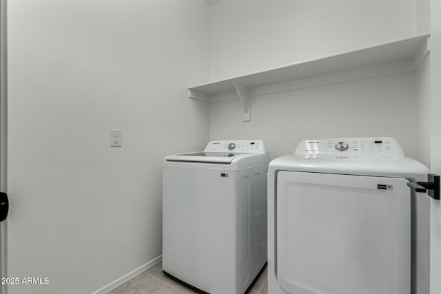 washroom with independent washer and dryer and light tile patterned floors