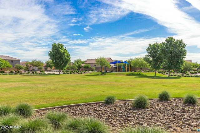 view of home's community with a playground and a lawn