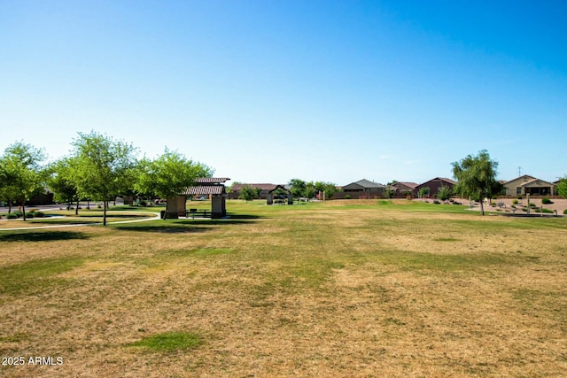 view of community featuring a lawn and a pergola