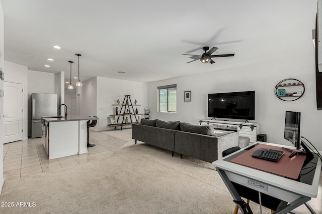 tiled living room featuring ceiling fan and sink