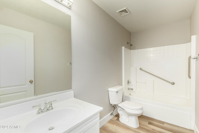 full bathroom with visible vents, toilet, bathtub / shower combination, wood finished floors, and vanity