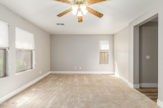 unfurnished room with visible vents, baseboards, ceiling fan, and carpet flooring