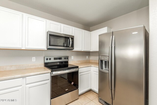 kitchen featuring stainless steel appliances, sink, and white cabinetry