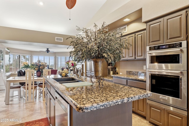 kitchen with a ceiling fan, visible vents, a sink, wine cooler, and double oven