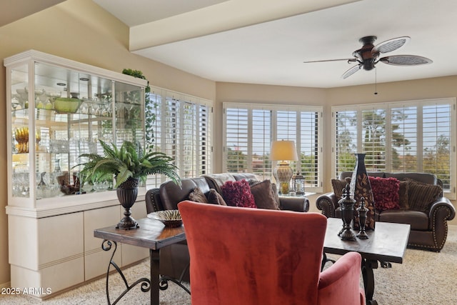 living room featuring carpet flooring and a ceiling fan