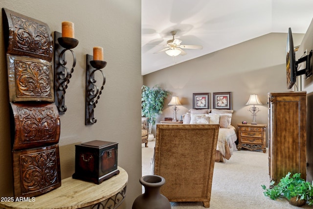 bedroom with vaulted ceiling, carpet flooring, and a ceiling fan