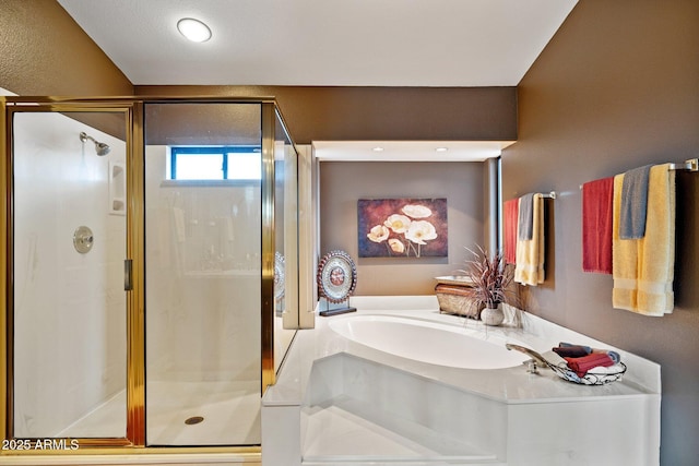 bathroom with a stall shower and a garden tub