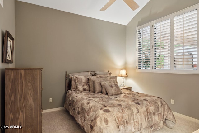 carpeted bedroom featuring baseboards, a ceiling fan, and vaulted ceiling