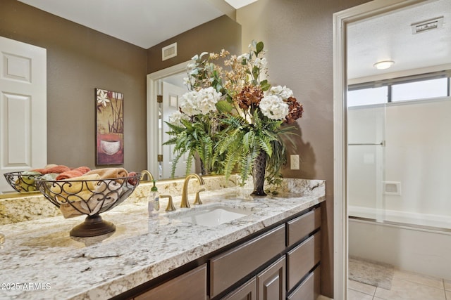 bathroom with tile patterned floors, visible vents, vanity, and shower / bathing tub combination