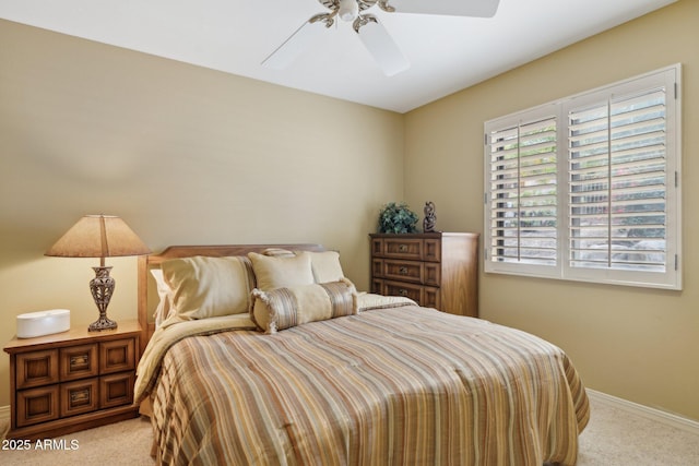 carpeted bedroom featuring baseboards and a ceiling fan