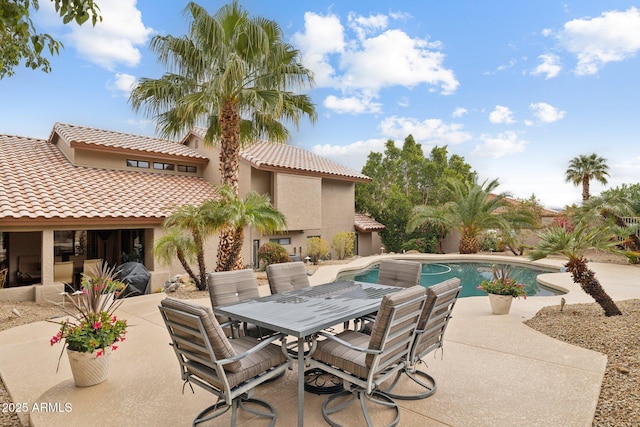 pool featuring a patio and outdoor dining space