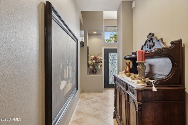 hallway featuring light tile patterned floors