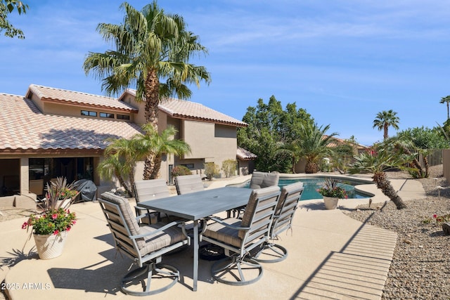 view of patio with an outdoor pool and outdoor dining area