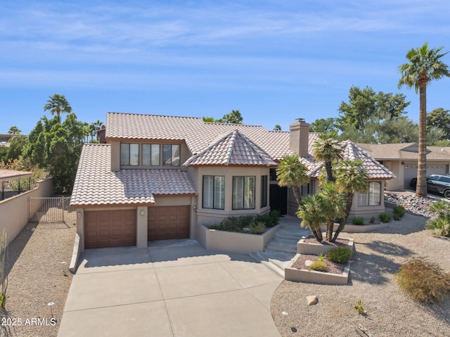 view of front of home featuring a tiled roof, fence, and stucco siding