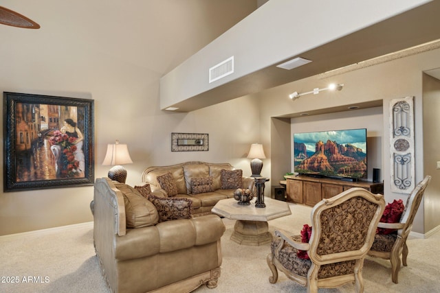 carpeted living area with visible vents and baseboards