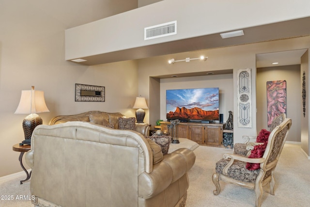 living area featuring visible vents, baseboards, and carpet