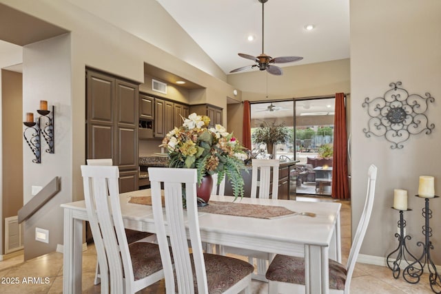 dining area with light tile patterned floors, visible vents, lofted ceiling, and ceiling fan