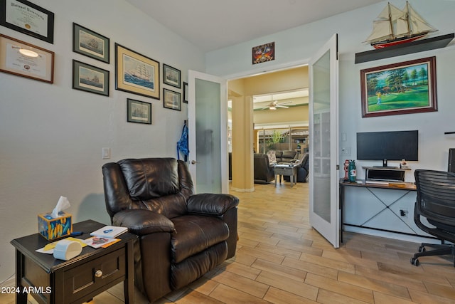 home office featuring ceiling fan, light hardwood / wood-style floors, and french doors