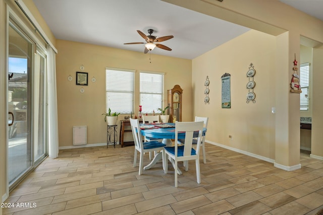 dining room with ceiling fan and light wood-type flooring