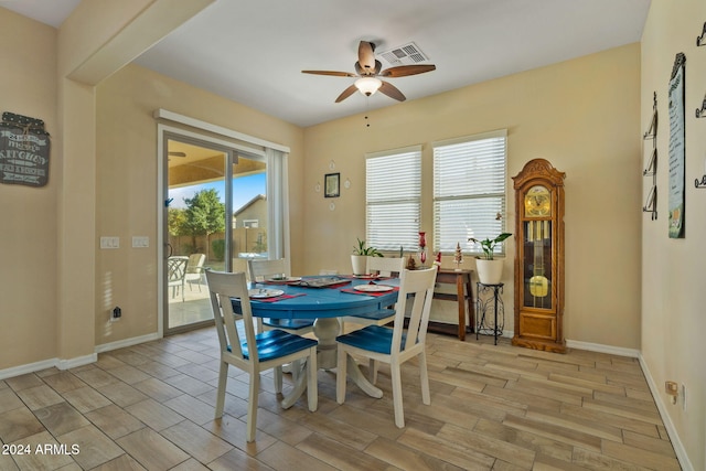 dining room with ceiling fan and light wood-type flooring