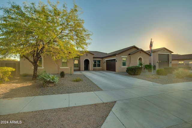 mediterranean / spanish-style home with a garage