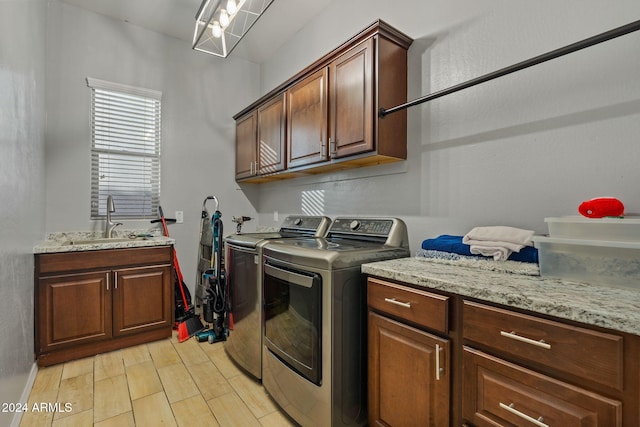 laundry room with separate washer and dryer, sink, and cabinets