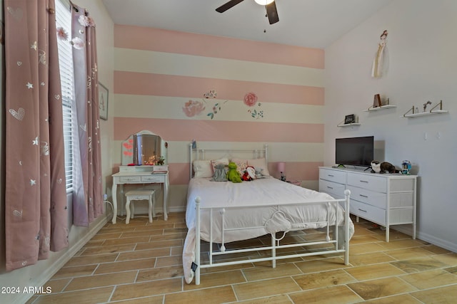 bedroom featuring multiple windows, ceiling fan, and light wood-type flooring