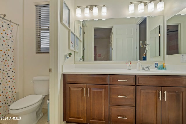 bathroom featuring tile patterned flooring, vanity, and toilet