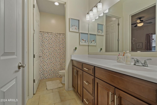 bathroom with vanity, ceiling fan, tile patterned flooring, toilet, and curtained shower