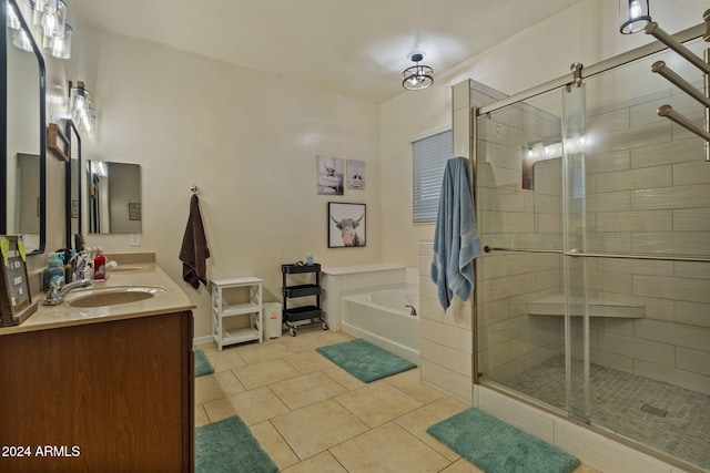 bathroom with shower with separate bathtub, vanity, and tile patterned floors