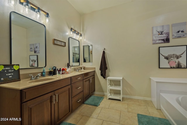 bathroom with tile patterned flooring, vanity, and a bathtub