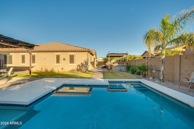 view of swimming pool featuring a lawn and a jacuzzi