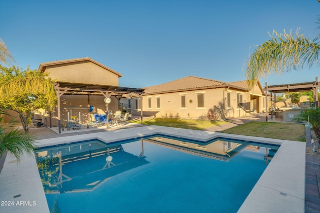 view of pool with a yard, a patio, and a hot tub